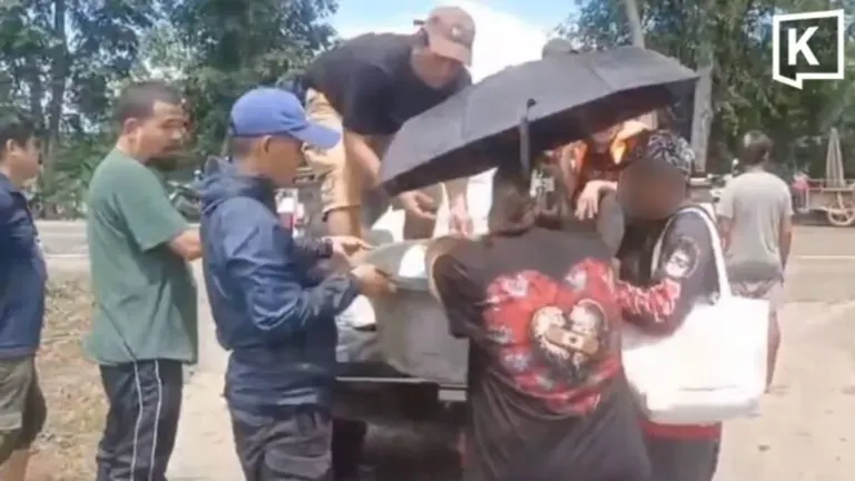 Family Carries Autistic Son in Basin Through Floodwaters